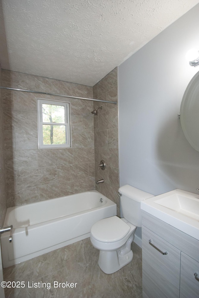 full bathroom with toilet,  shower combination, a textured ceiling, and vanity