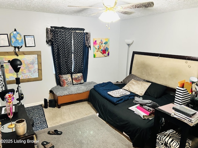 carpeted bedroom with a textured ceiling, a ceiling fan, and baseboards