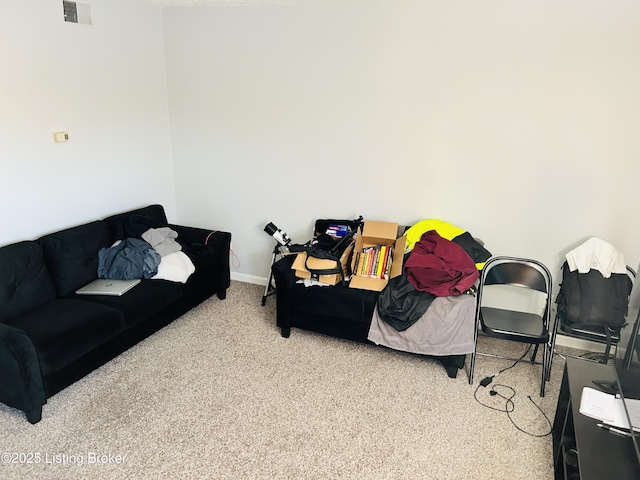 living room featuring carpet floors, visible vents, and baseboards