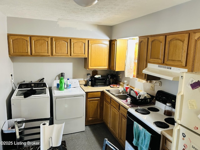 kitchen with washing machine and dryer, under cabinet range hood, electric stove, freestanding refrigerator, and brown cabinets