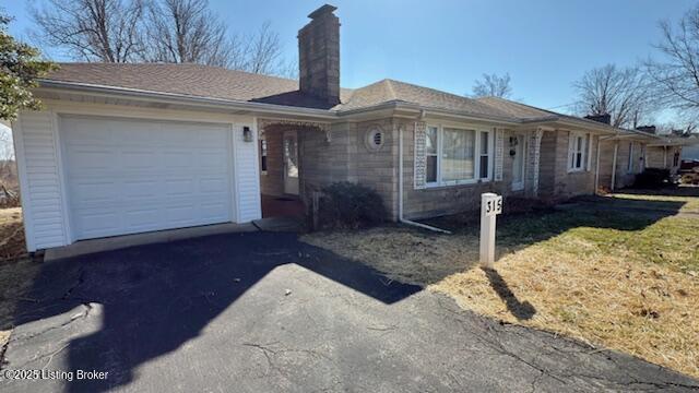 single story home with a garage and driveway