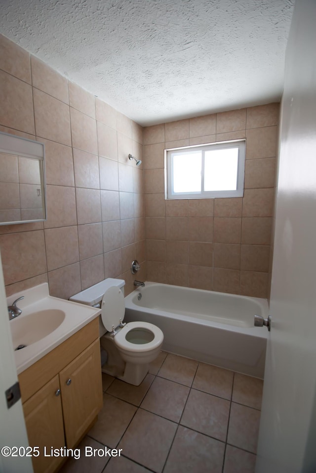 bathroom featuring toilet, tub / shower combination, a textured ceiling, vanity, and tile patterned flooring