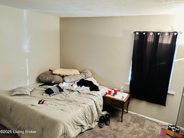 carpeted bedroom featuring a textured ceiling