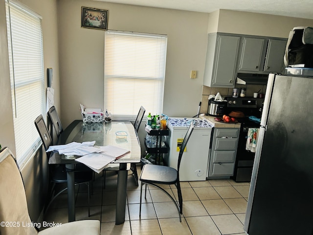 dining area with light tile patterned flooring