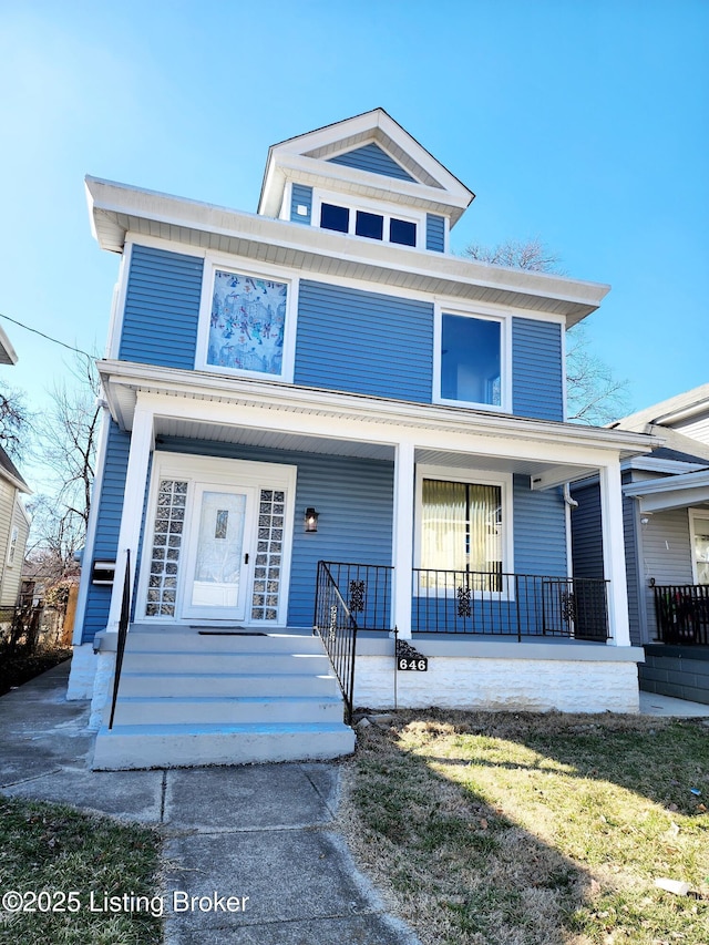 american foursquare style home featuring covered porch