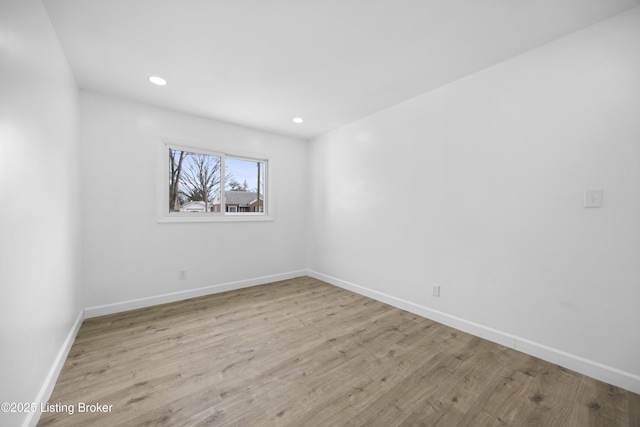 empty room featuring light wood-style floors, baseboards, and recessed lighting