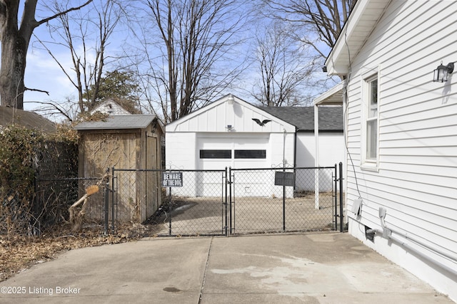 view of patio / terrace with a shed, a gate, fence, and an outdoor structure