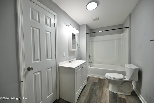 full bath featuring toilet, shower / bath combination, wood finished floors, visible vents, and vanity