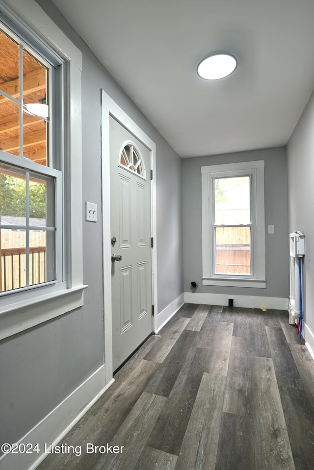 interior space featuring baseboards and dark wood-style flooring