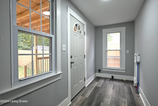 doorway featuring dark wood-style floors and baseboards