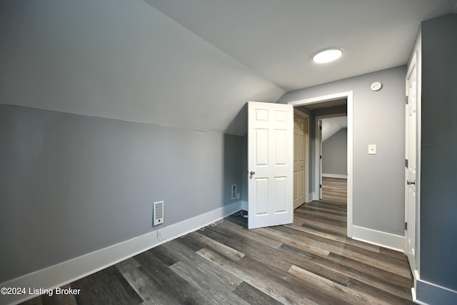 bonus room with dark wood-type flooring, visible vents, vaulted ceiling, and baseboards