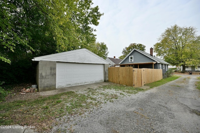 detached garage featuring fence