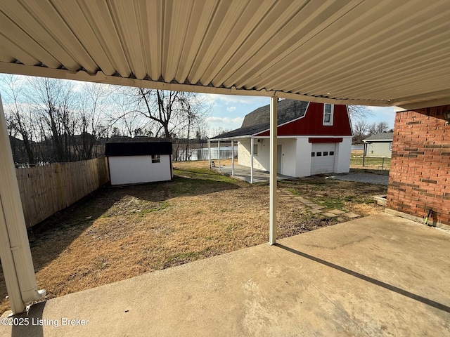 view of patio with an outdoor structure and fence