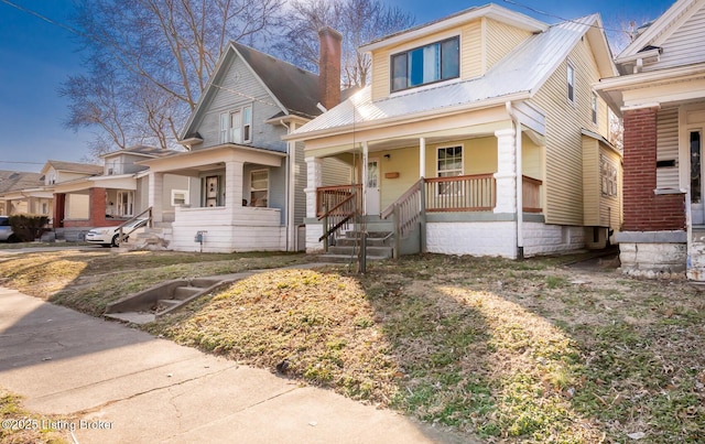 view of front of house featuring metal roof and a porch