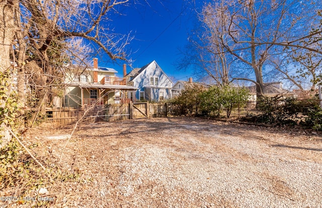 back of house with a gate and fence