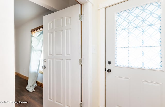 doorway to outside with dark wood-type flooring and baseboards