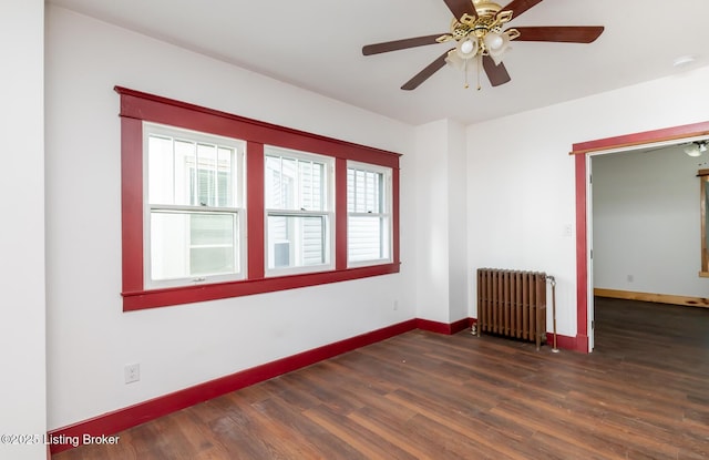 unfurnished room with baseboards, ceiling fan, wood finished floors, and radiator