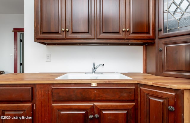 kitchen featuring butcher block counters and a sink