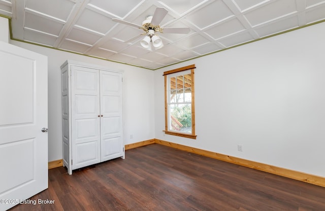 unfurnished bedroom with dark wood-style flooring, ceiling fan, and baseboards