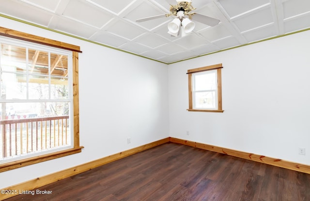 spare room featuring an ornate ceiling, dark wood-style flooring, ceiling fan, and baseboards