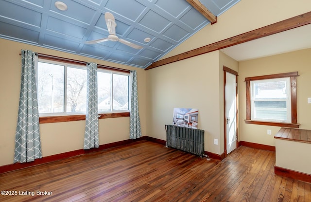 empty room with dark wood-style floors, a wealth of natural light, radiator, and baseboards