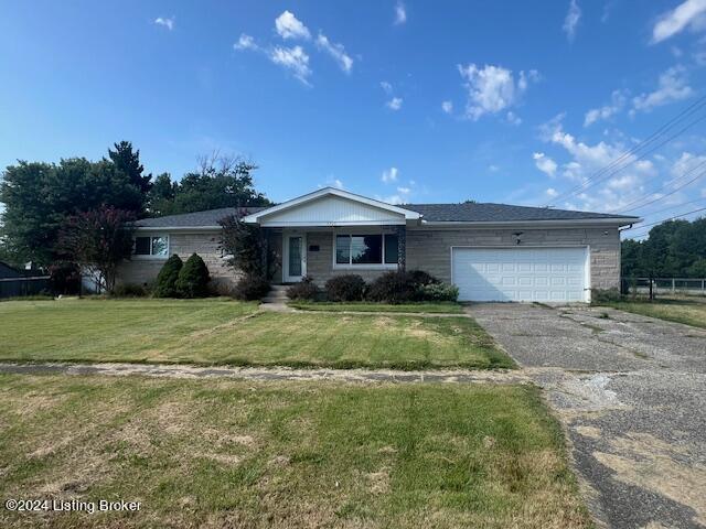 single story home featuring an attached garage, driveway, and a front lawn