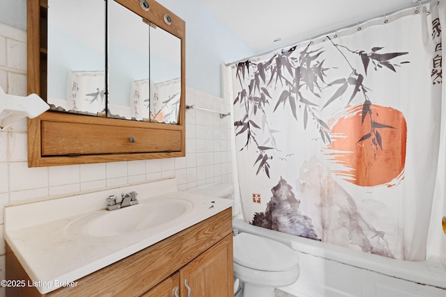 full bathroom featuring toilet, shower / tub combo, vanity, and tile walls