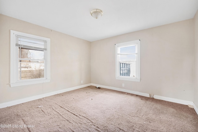 spare room with carpet flooring and baseboards