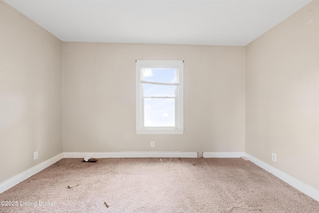 carpeted empty room with baseboards