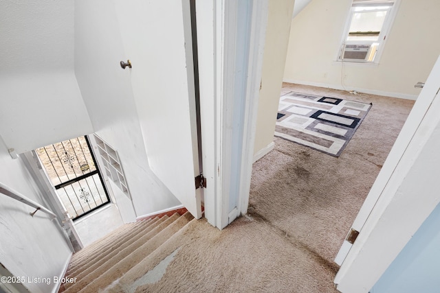 stairs with cooling unit, carpet flooring, and baseboards