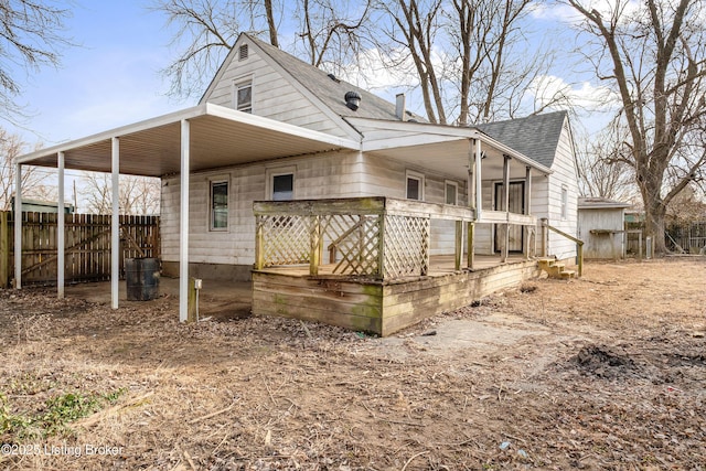 back of property featuring roof with shingles, fence, and a chimney