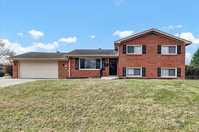 tri-level home featuring driveway, a front lawn, an attached garage, and brick siding