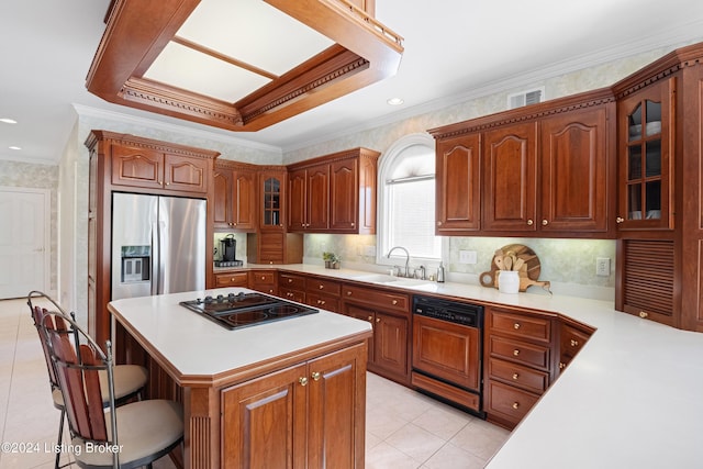 kitchen with paneled dishwasher, light countertops, a sink, and black electric cooktop