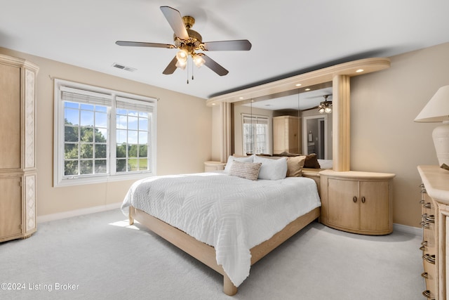 bedroom with light colored carpet, visible vents, and baseboards