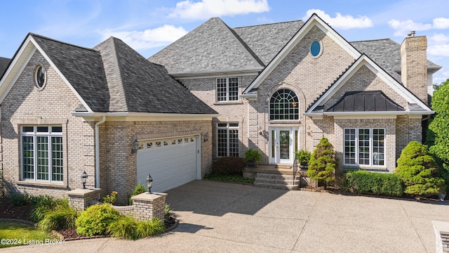 view of front of house with an attached garage, brick siding, concrete driveway, roof with shingles, and a chimney