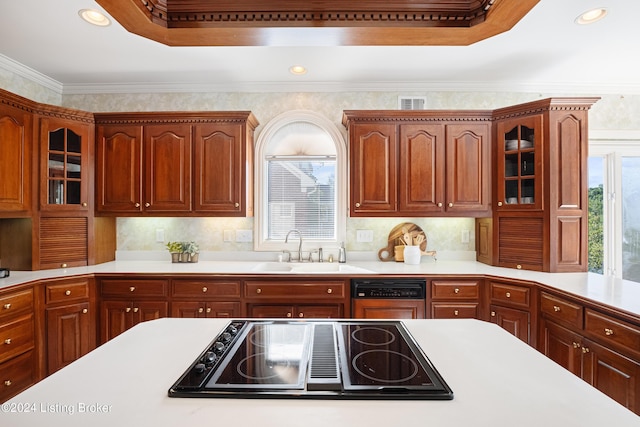 kitchen featuring light countertops, black electric cooktop, dishwasher, and a raised ceiling