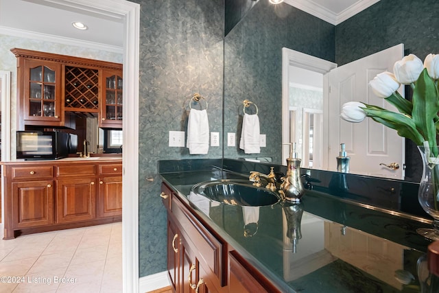 bathroom with wallpapered walls, vanity, crown molding, and tile patterned floors