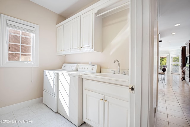 laundry room with recessed lighting, a sink, baseboards, cabinet space, and washer and clothes dryer