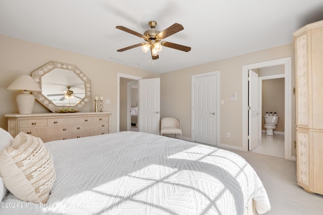 bedroom with light carpet, visible vents, baseboards, ceiling fan, and ensuite bathroom