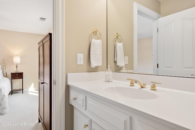 bathroom with ensuite bath, vanity, and visible vents