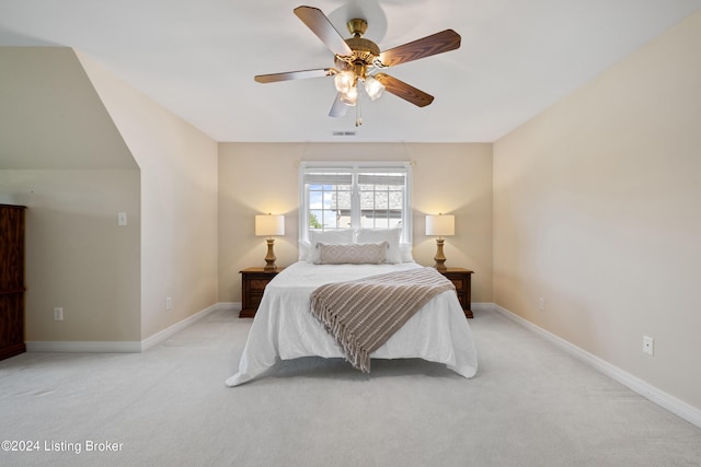 carpeted bedroom with a ceiling fan, visible vents, and baseboards