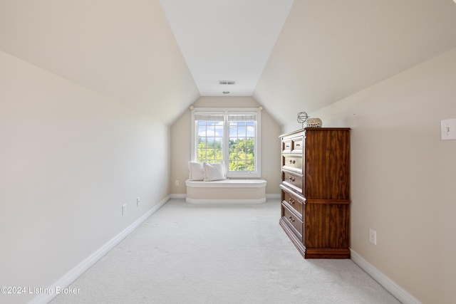 bonus room with light carpet, vaulted ceiling, visible vents, and baseboards