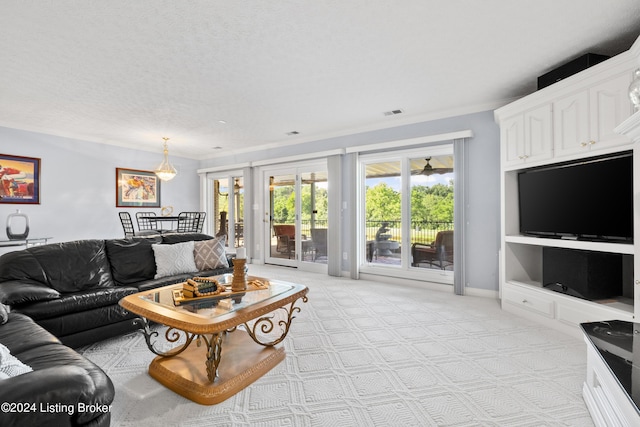 living room featuring baseboards, a textured ceiling, and light colored carpet