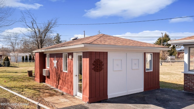 view of outbuilding featuring fence and an outdoor structure