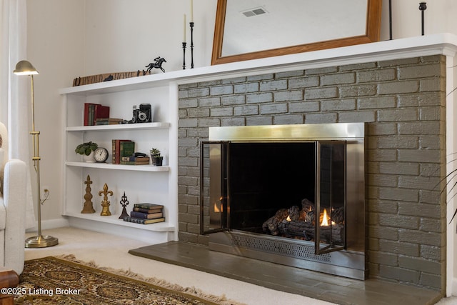 interior details featuring visible vents and a fireplace