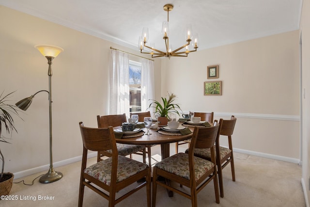 dining space featuring light carpet, crown molding, baseboards, and an inviting chandelier