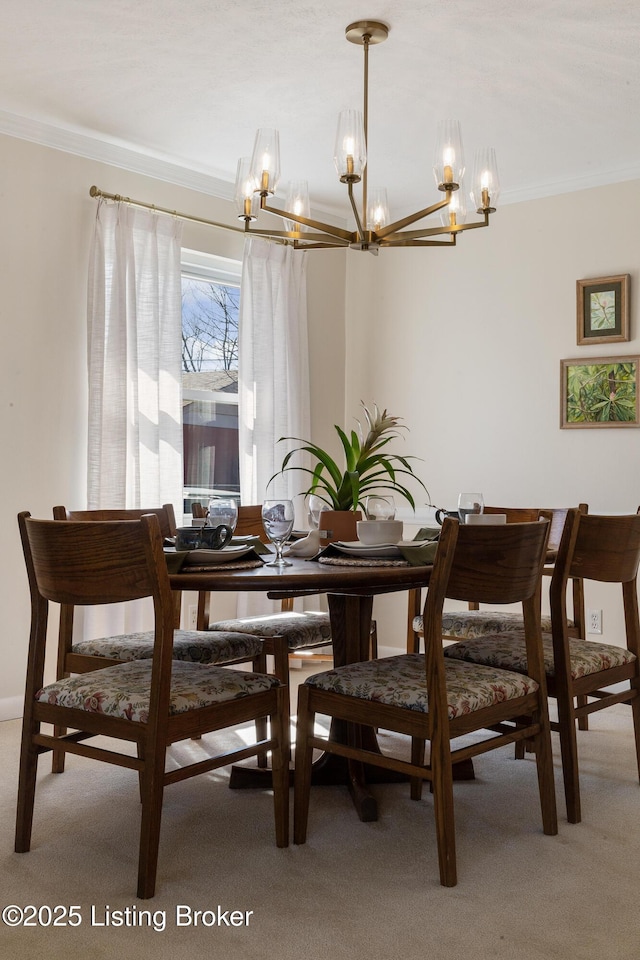 carpeted dining space with crown molding