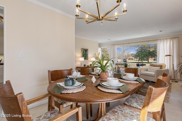 dining area with a chandelier, carpet flooring, crown molding, and baseboards