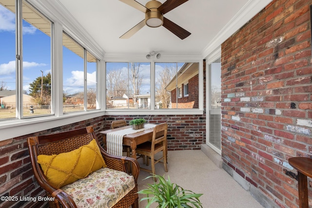 sunroom / solarium featuring a ceiling fan