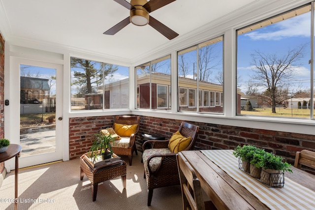 sunroom featuring ceiling fan and a wealth of natural light